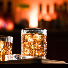 Whiskey glasses with ice in a lounge bar